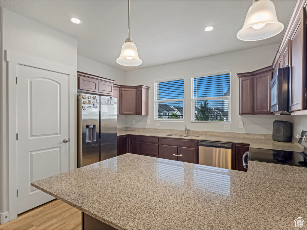 Kitchen with a sink, a peninsula, recessed lighting, and appliances with stainless steel finishes