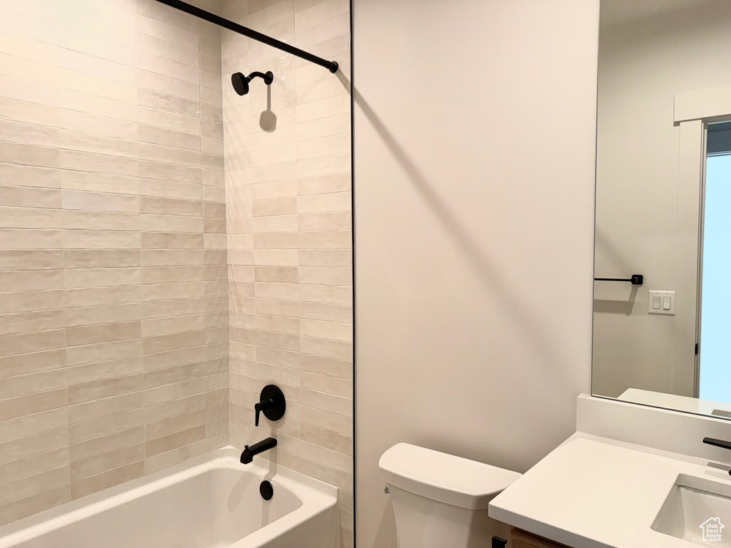 Bathroom featuring toilet, shower / washtub combination, and vanity