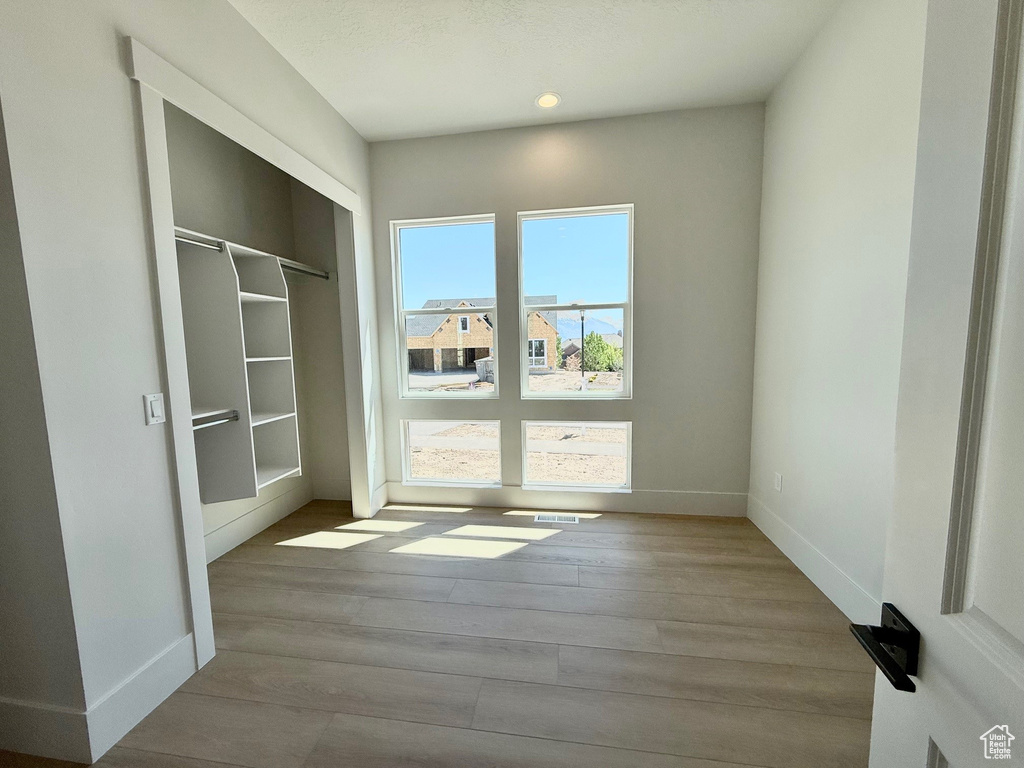 Doorway to outside with wood finished floors, baseboards, and recessed lighting