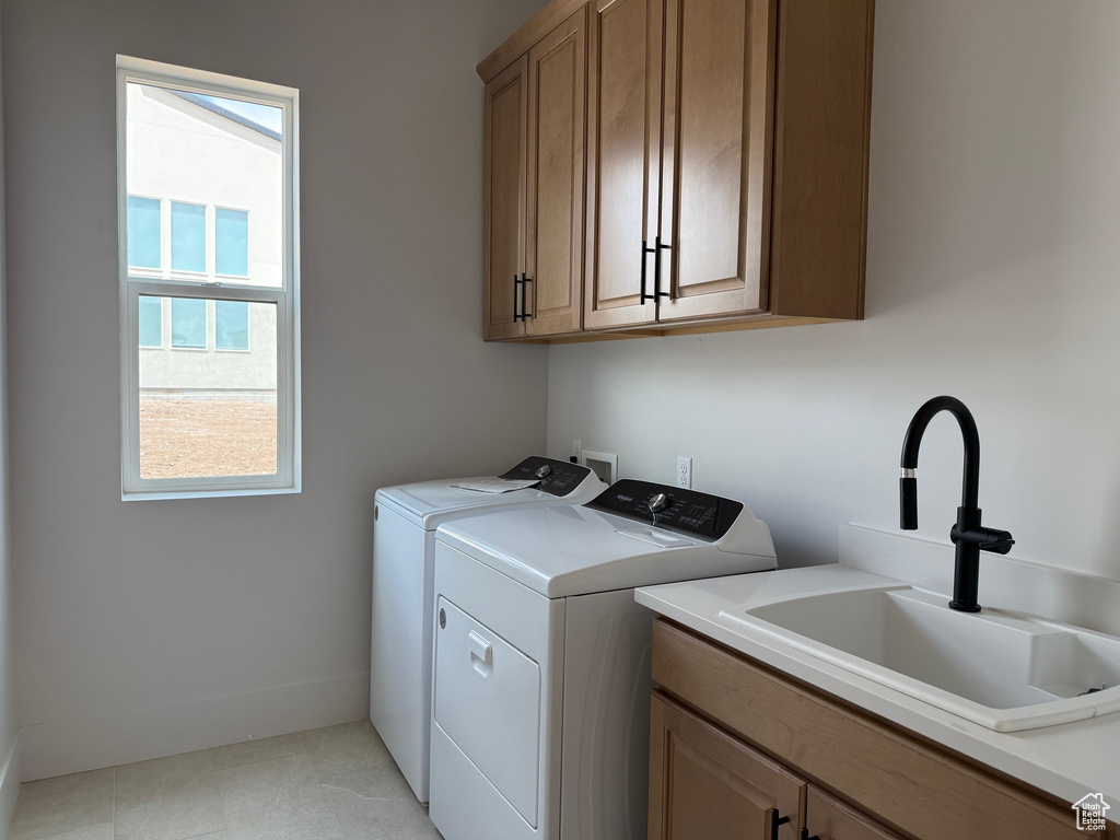 Laundry room with washer and dryer, cabinet space, and plenty of natural light