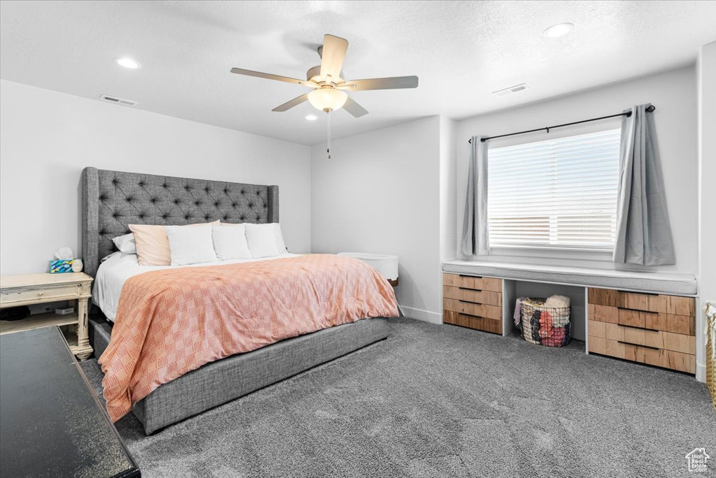 Carpeted bedroom featuring recessed lighting, ceiling fan, and baseboards