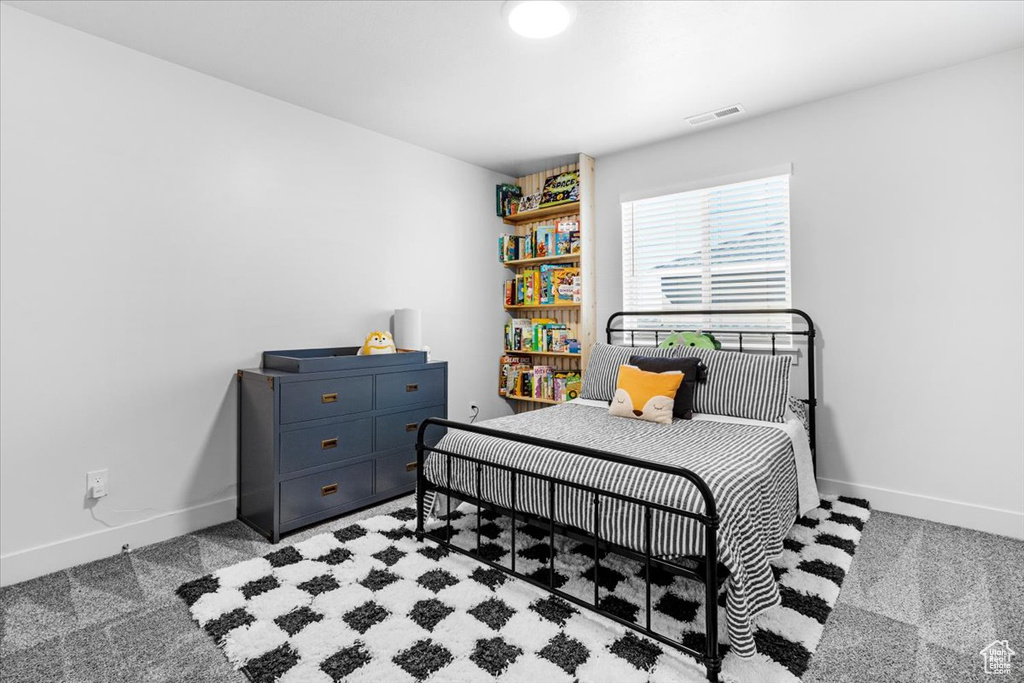 Carpeted bedroom featuring baseboards