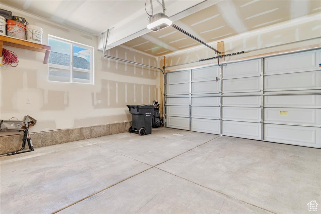Garage featuring a garage door opener