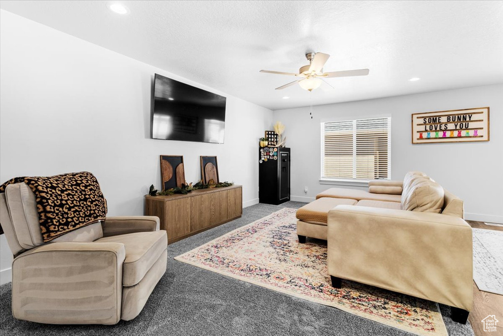 Living room with ceiling fan, baseboards, recessed lighting, and carpet floors