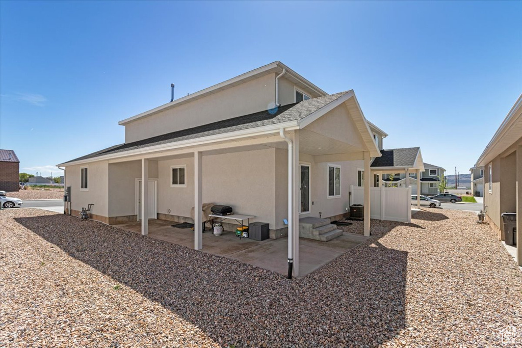 Back of property with a patio area and stucco siding