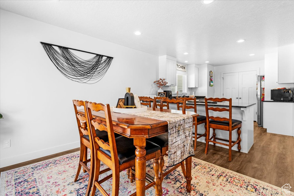 Dining area featuring recessed lighting, light wood-style flooring, and baseboards