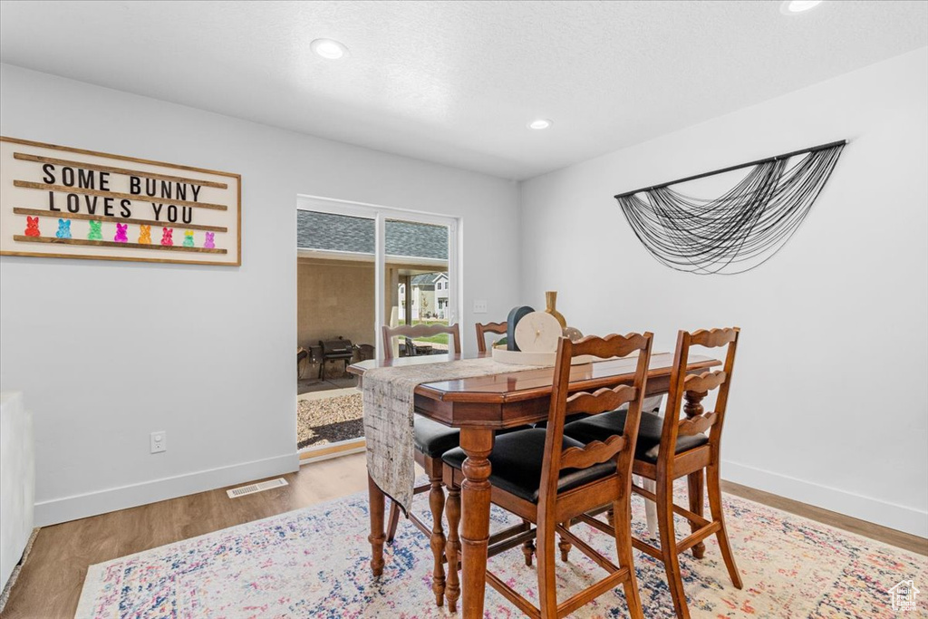 Dining space with recessed lighting, baseboards, and light wood-style flooring