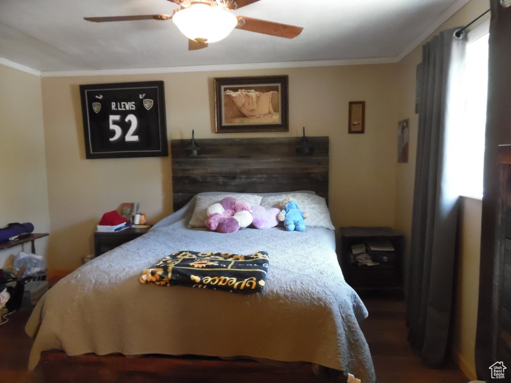 Bedroom with crown molding and ceiling fan