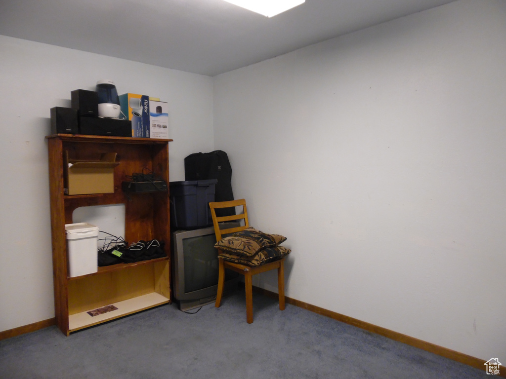 Carpeted home office featuring baseboards
