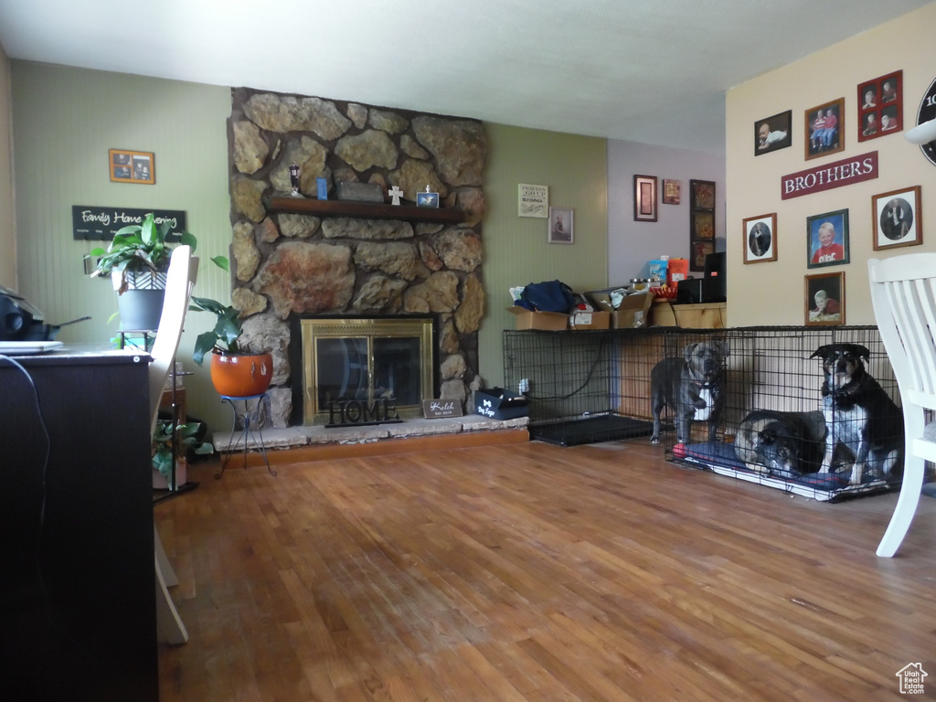 Living room featuring wood finished floors and a fireplace