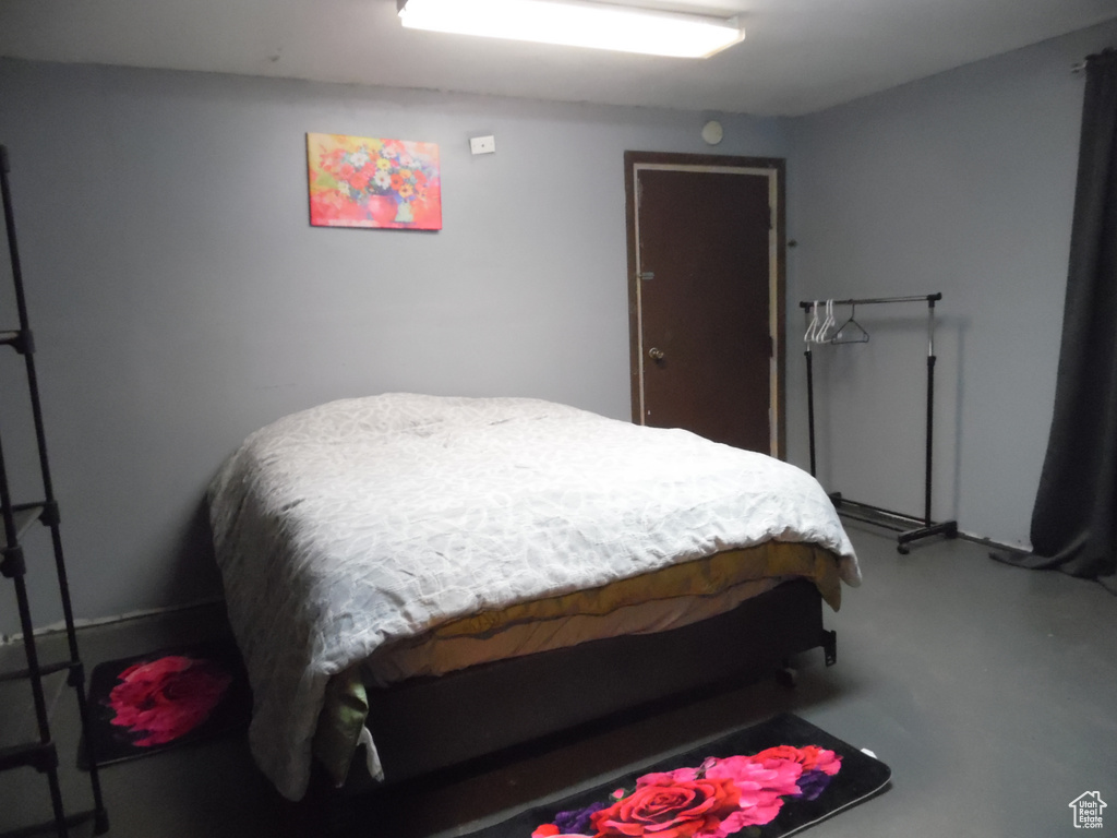 Bedroom featuring concrete flooring