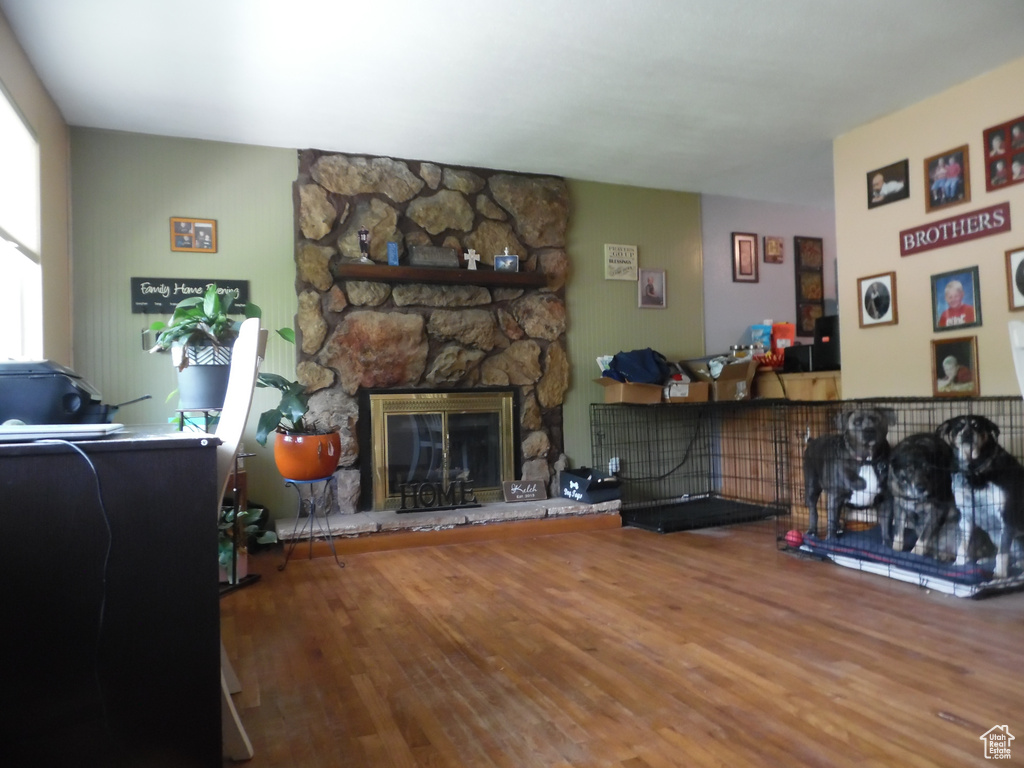 Living area featuring wood finished floors and a stone fireplace