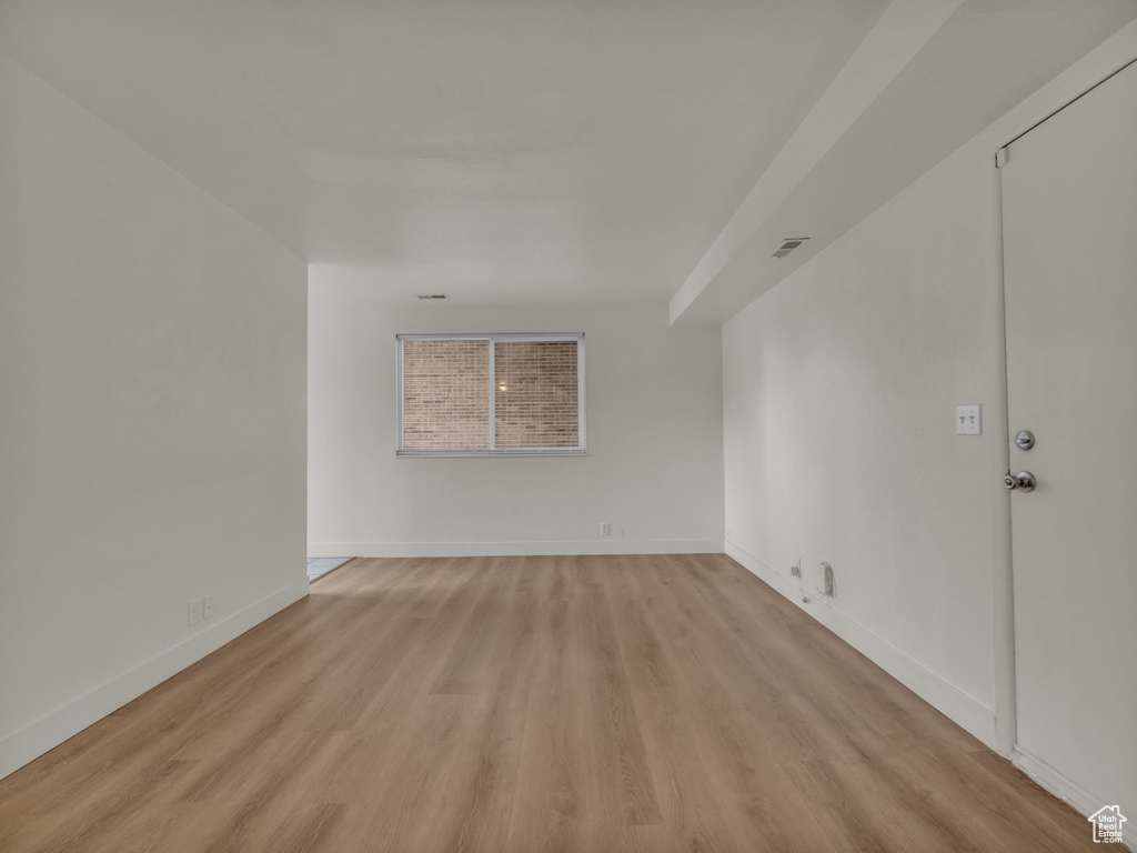 Unfurnished room featuring light wood-style floors and baseboards