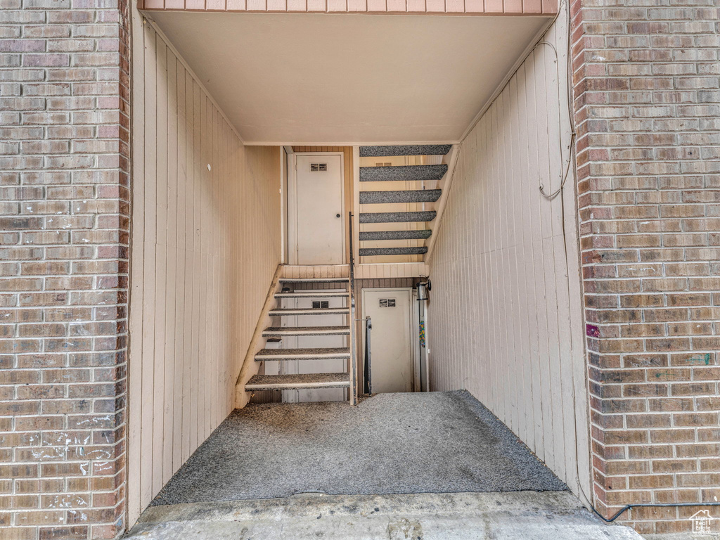 Doorway to property with brick siding