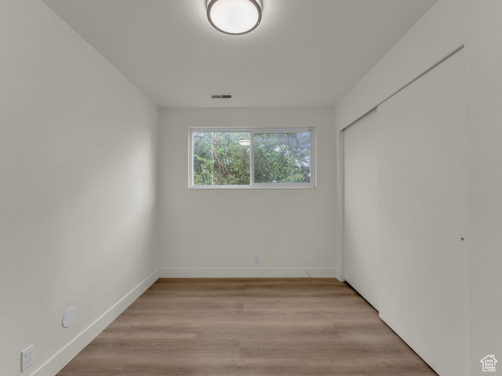 Unfurnished room with baseboards and light wood finished floors