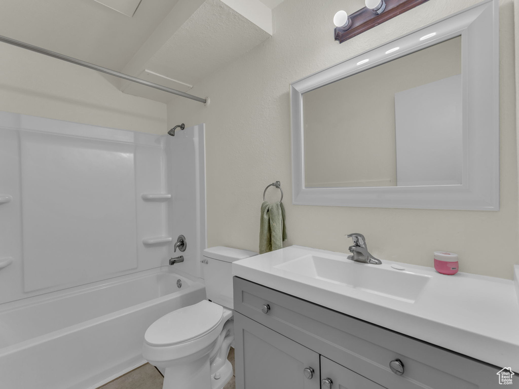 Full bathroom featuring toilet, vanity, and bathtub / shower combination