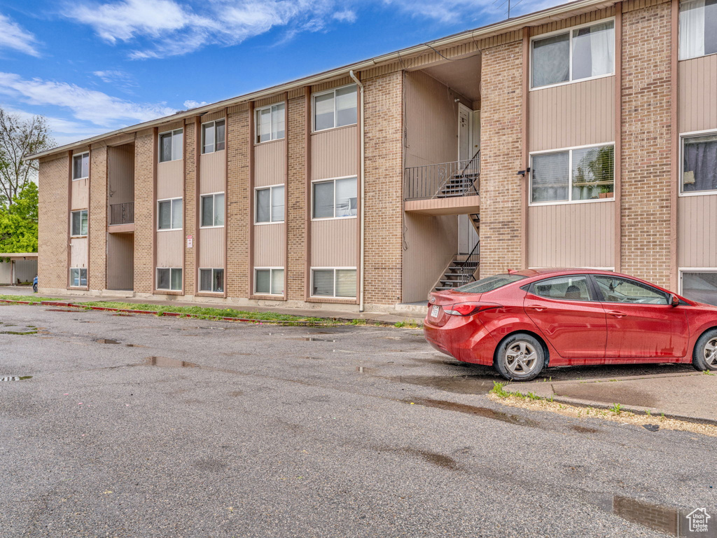 View of property featuring uncovered parking