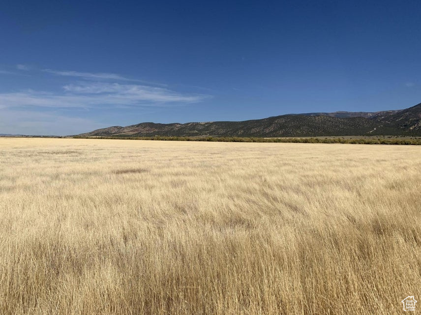 View of mountain background featuring rural landscape