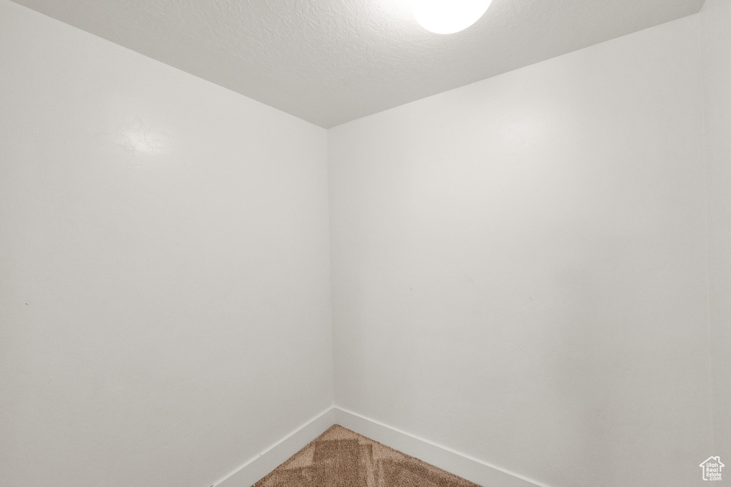 Empty room with baseboards and light carpet