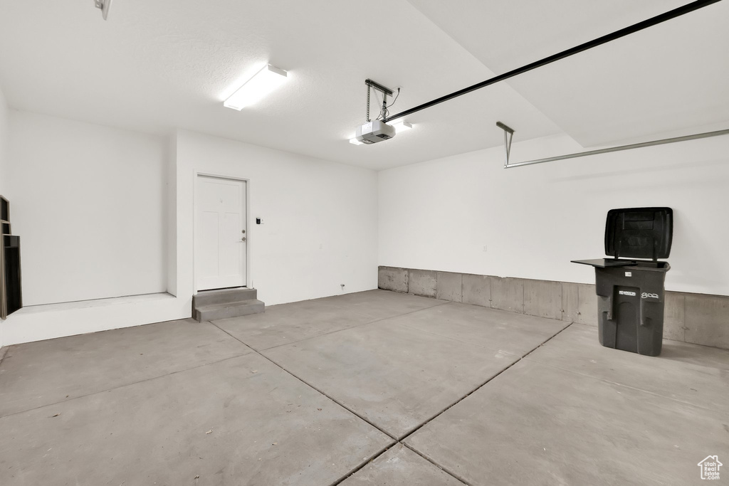 Garage featuring a garage door opener
