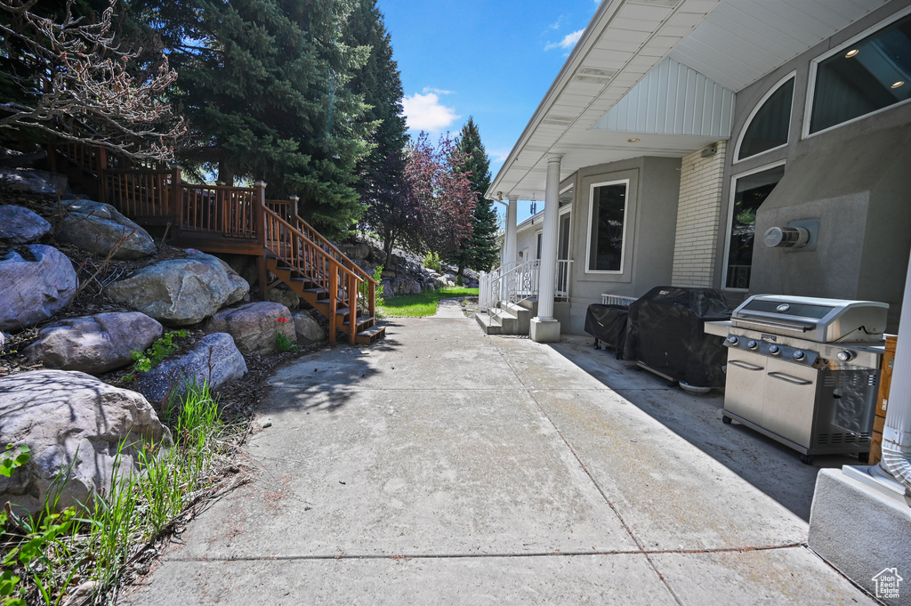 View of patio / terrace with stairway and a grill