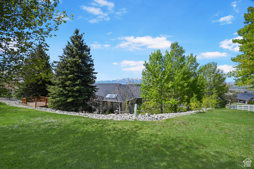 View of yard featuring a deck with mountain view