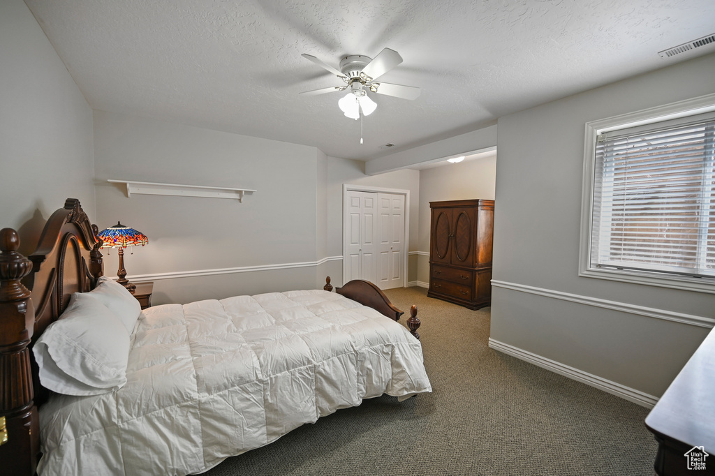Bedroom featuring a ceiling fan, a closet, carpet, baseboards, and visible vents