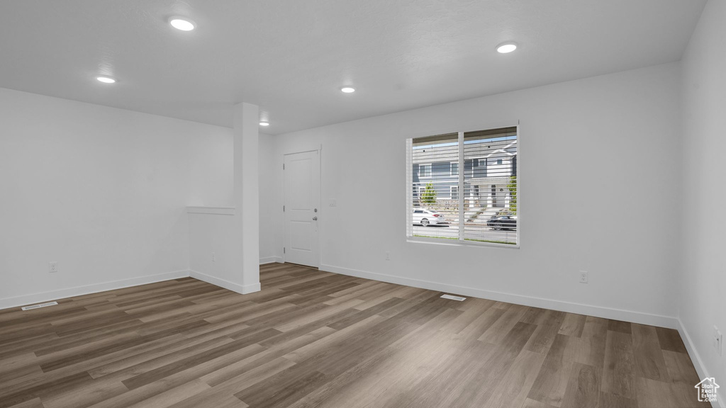 Empty room with recessed lighting, wood finished floors, and baseboards