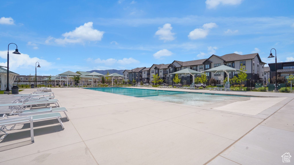 Community pool with a residential view and a patio