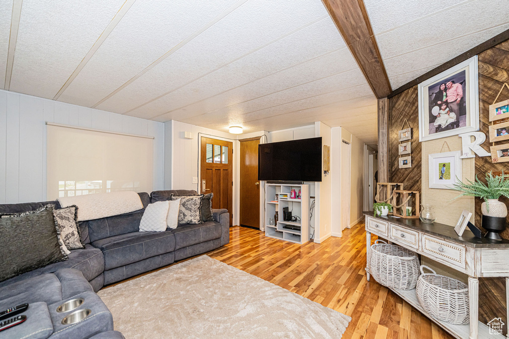 Living area featuring light wood-type flooring and a textured ceiling