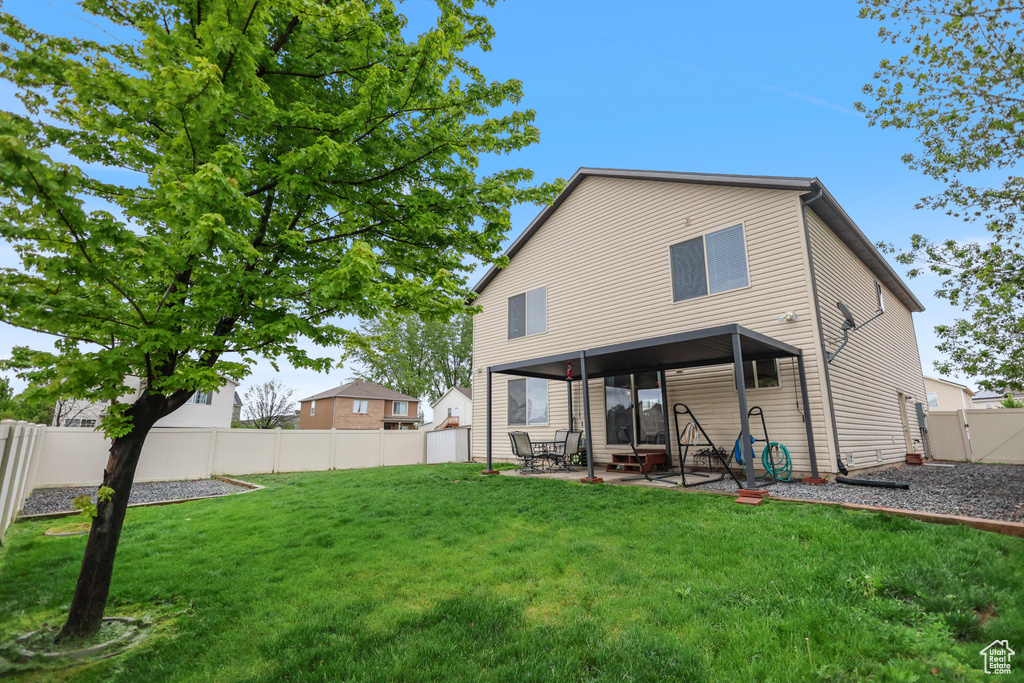 Back of property with a patio area and a gate