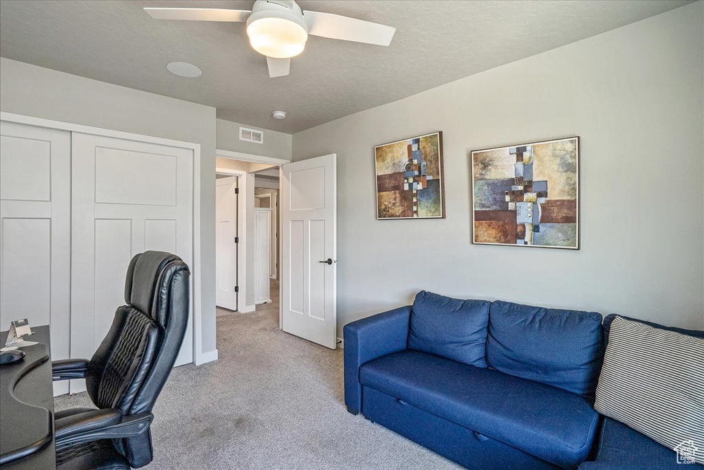 Office space featuring carpet flooring and a ceiling fan