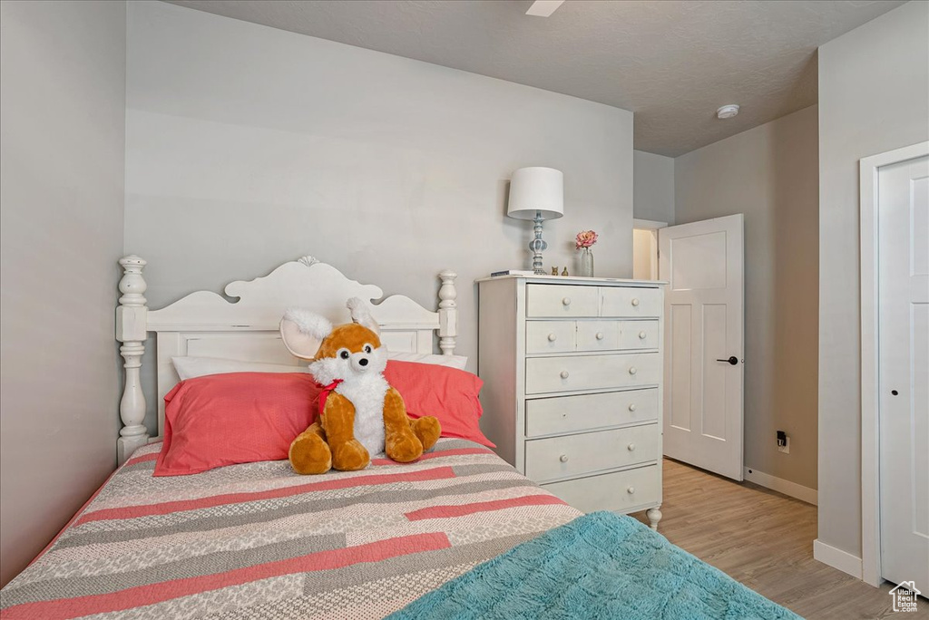 Bedroom featuring wood finished floors and baseboards