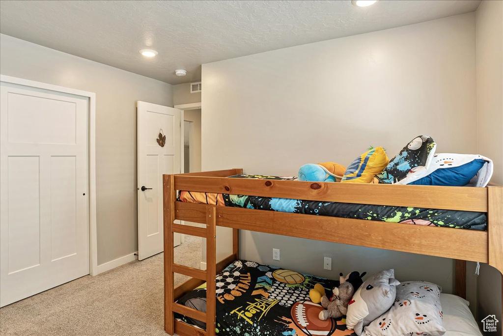 Bedroom with carpet flooring, baseboards, and recessed lighting