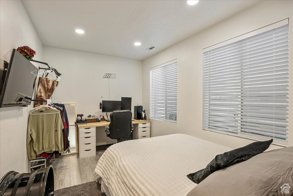 Bedroom featuring wood finished floors, recessed lighting, and an office area