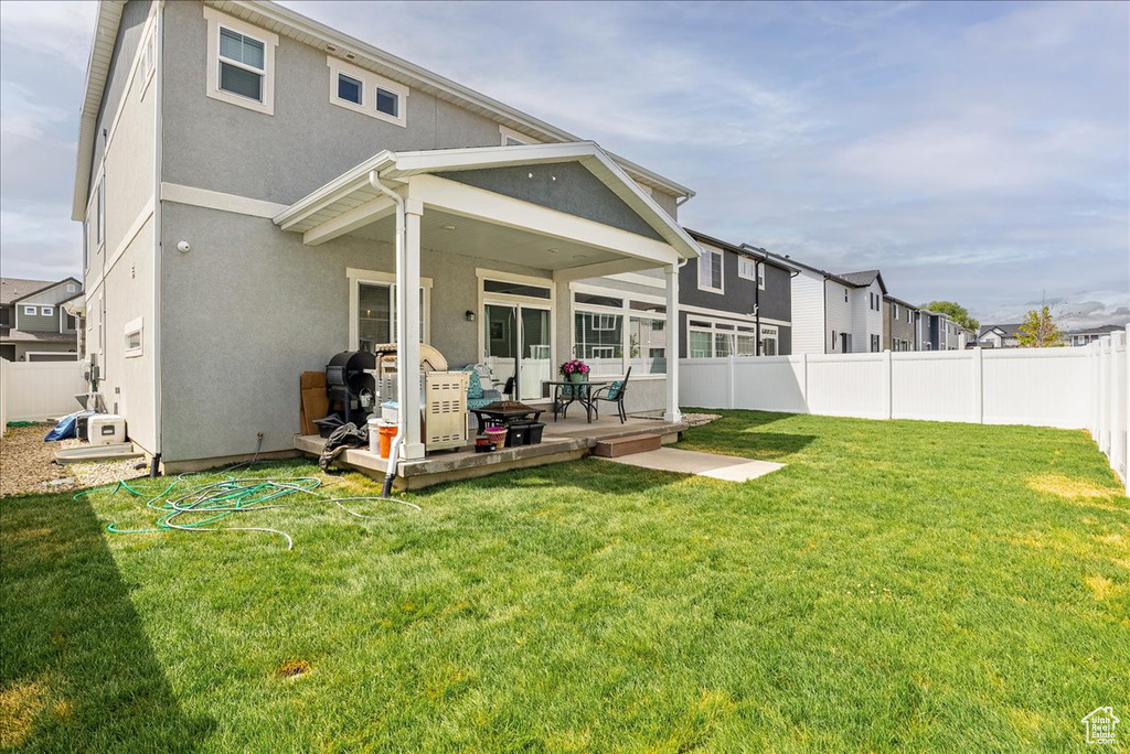 Back of property featuring stucco siding, a wooden deck, and a residential view
