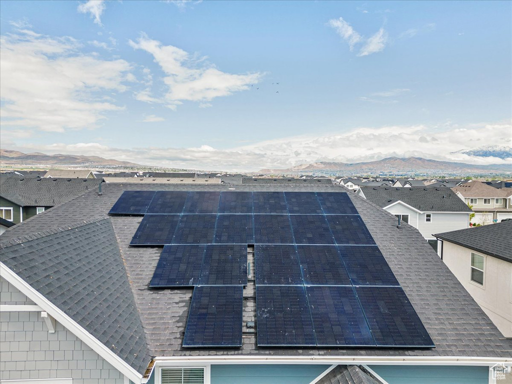 Exterior view of a shingled roof, a mountain view, and a residential view