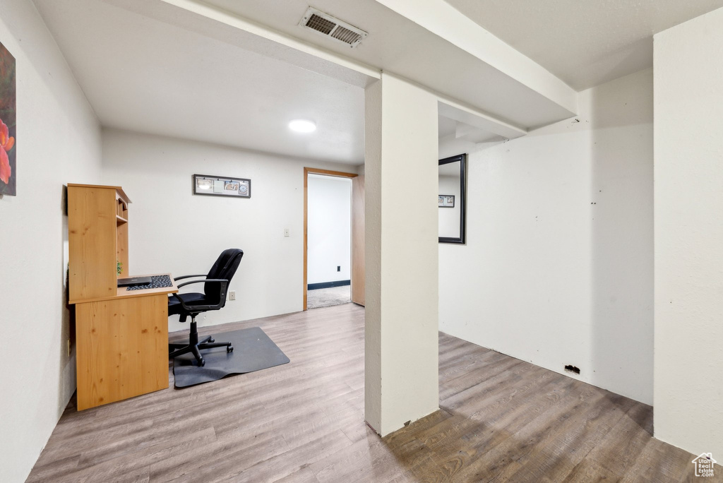 Office space featuring wood finished floors and recessed lighting