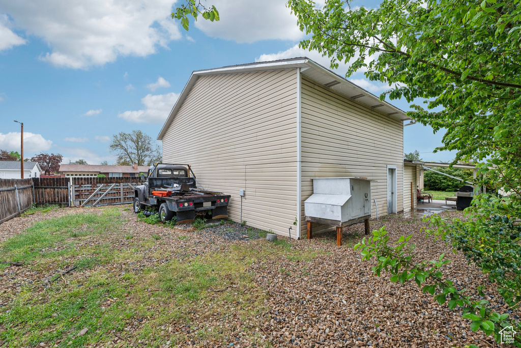 View of side of home with a fenced backyard