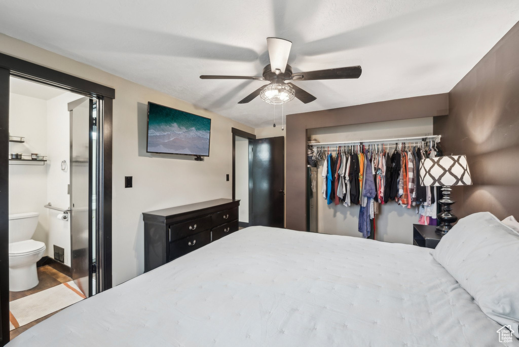 Bedroom featuring a closet, ensuite bath, and ceiling fan