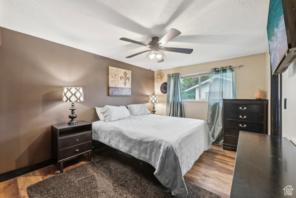 Bedroom with wood finished floors and a ceiling fan