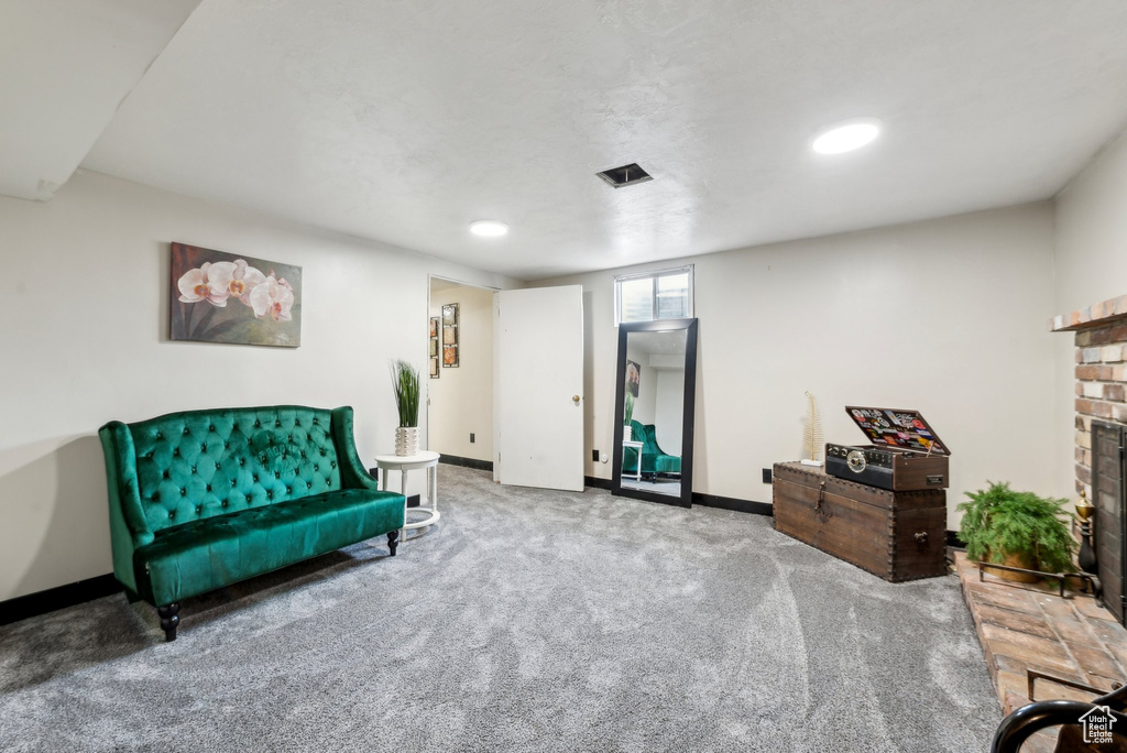 Living area featuring a fireplace, carpet floors, baseboards, and recessed lighting