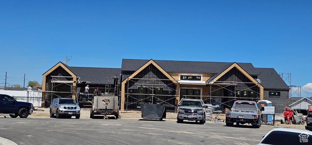 View of building exterior with uncovered parking