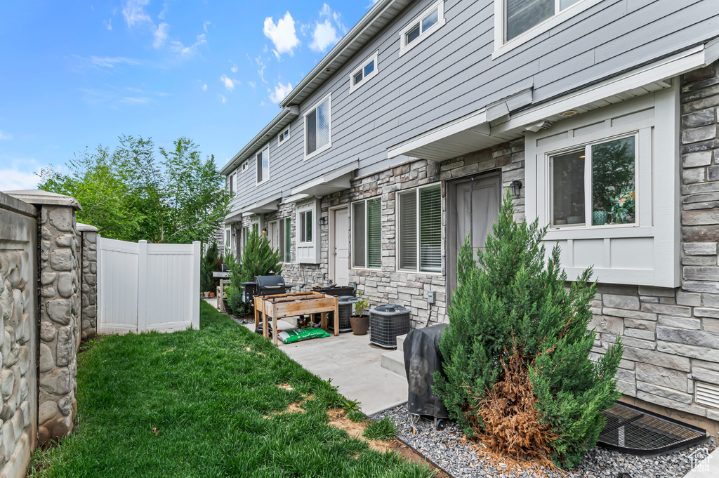 View of yard featuring central air condition unit and a patio area