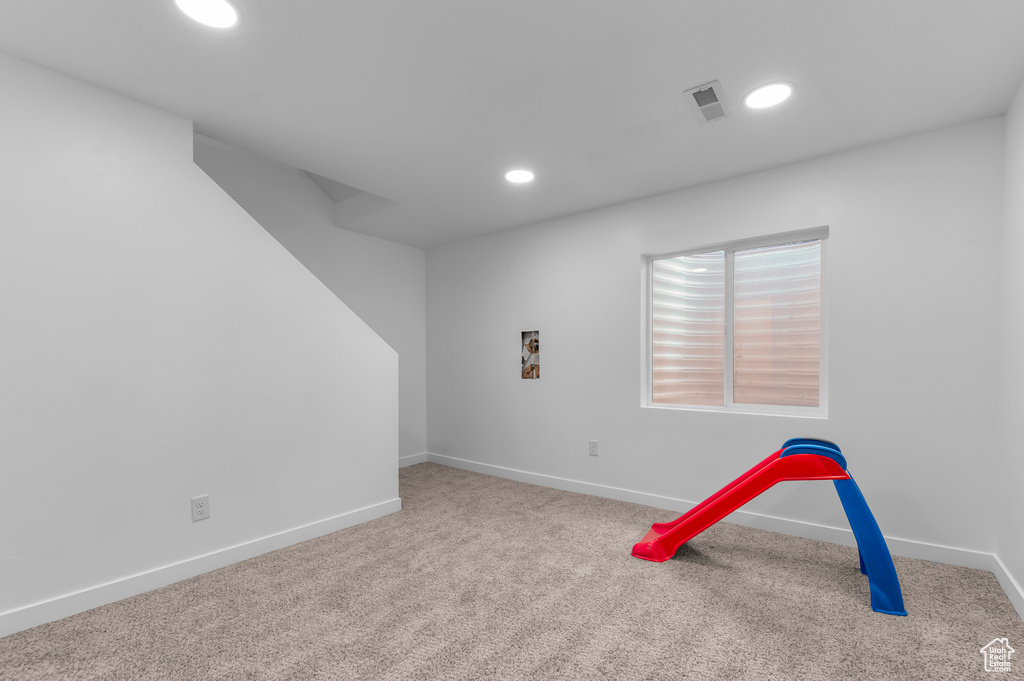 Recreation room with carpet floors, recessed lighting, and baseboards