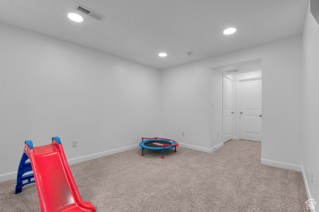 Recreation room featuring carpet floors, baseboards, and recessed lighting