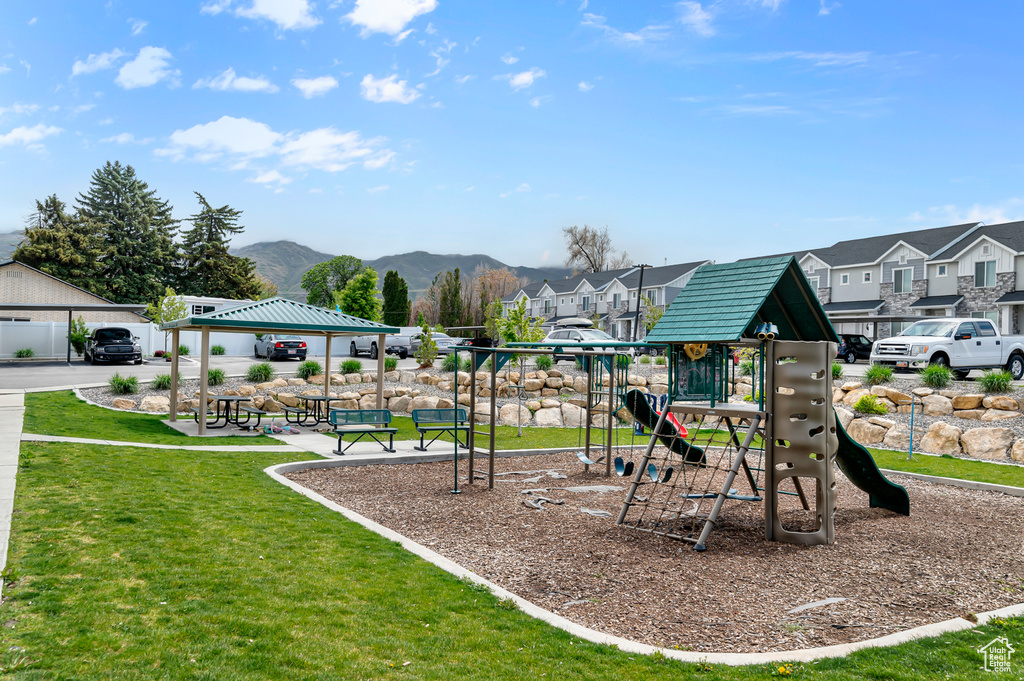 Community jungle gym featuring a gazebo, a yard, a mountain view, and a residential view