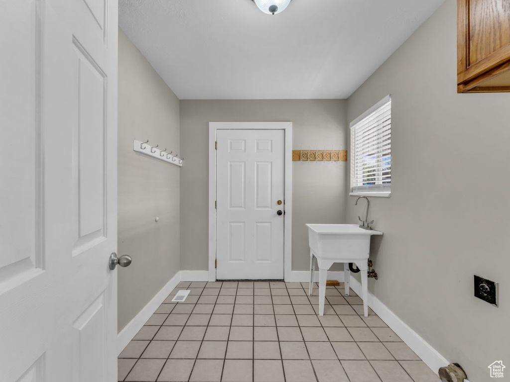 Interior space with baseboards and light tile patterned floors