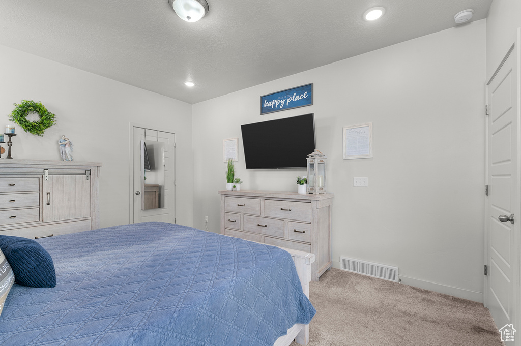 Bedroom with carpet floors, baseboards, and recessed lighting