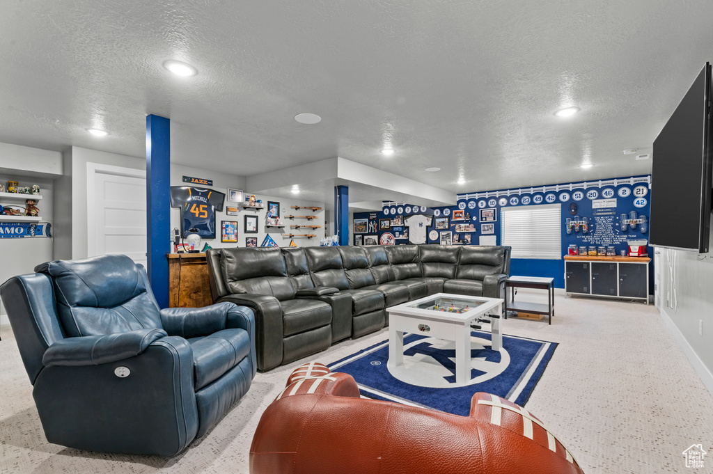 Living room featuring a textured ceiling, a dry bar, and recessed lighting